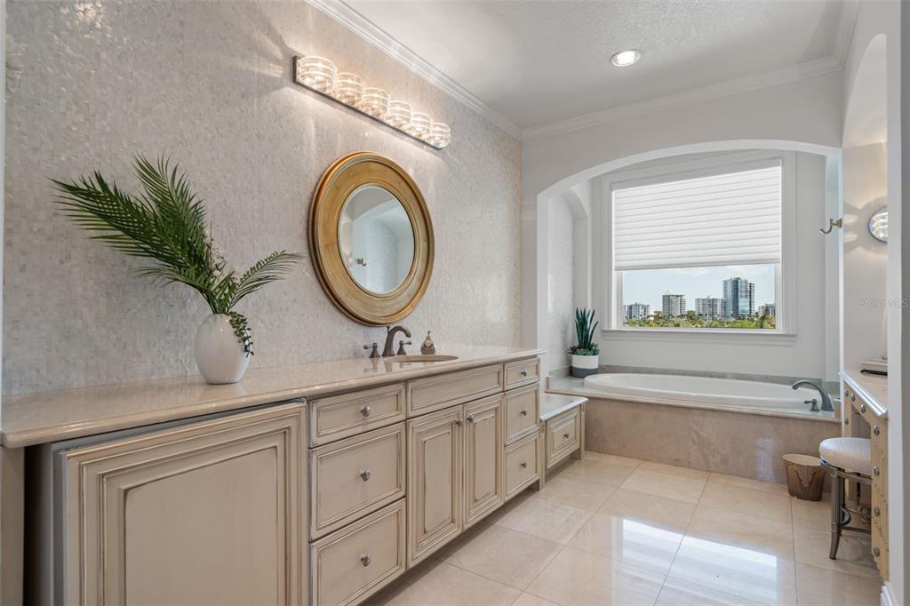 464 Golden Gate Point, Unit 703 Sarasota, FL 34236 - Photo 48 of 88 a bathroom with a sink and a mirror