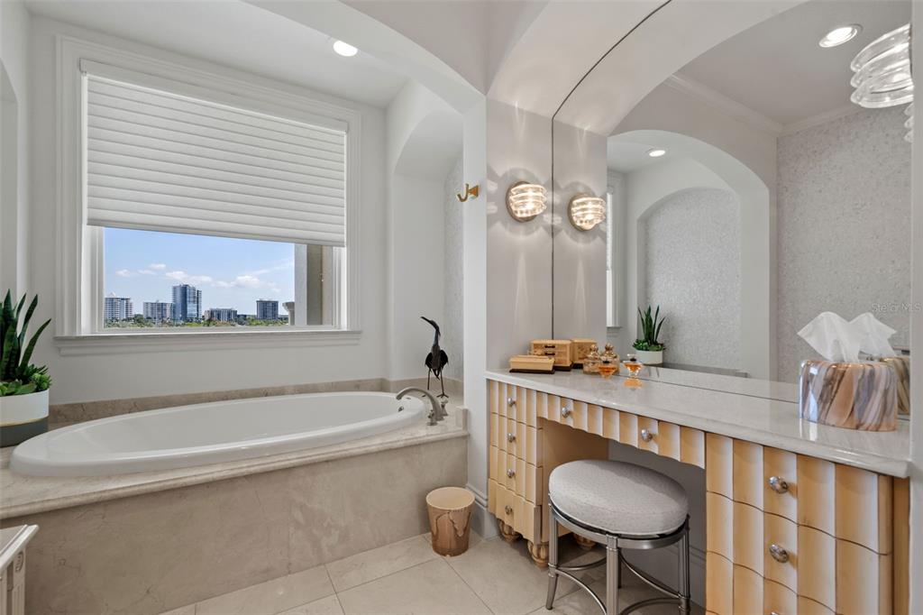 464 Golden Gate Point, Unit 703 Sarasota, FL 34236 - Photo 51 of 88 a bathroom with a granite countertop sink a toilet a mirror and bathtub