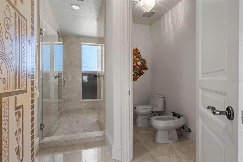 464 Golden Gate Point, Unit 703 Sarasota, FL 34236 - Photo 52 of 88 a bathroom with a toilet and a shower