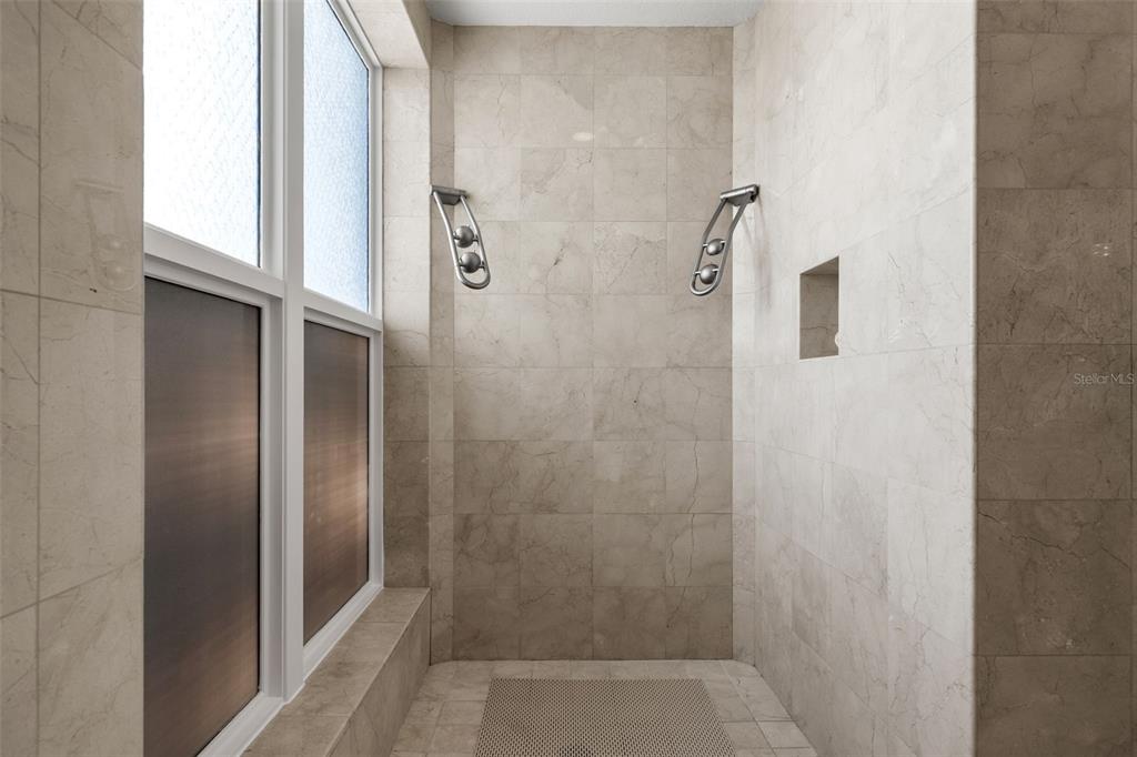 464 Golden Gate Point, Unit 703 Sarasota, FL 34236 - Photo 54 of 88 a bathroom with a glass shower door