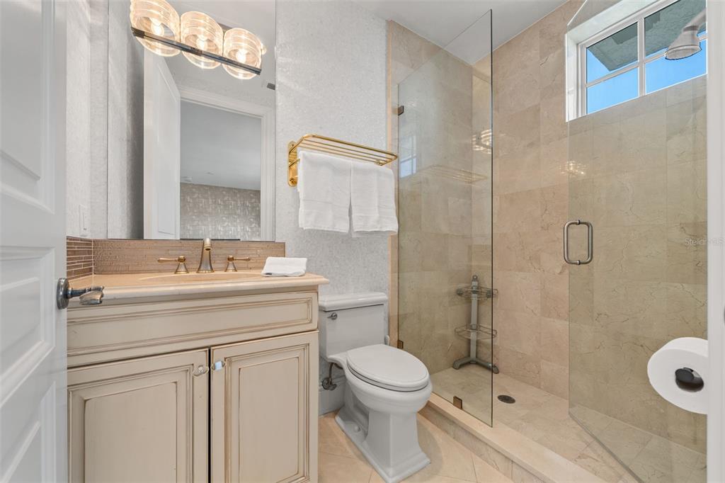 464 Golden Gate Point, Unit 703 Sarasota, FL 34236 - Photo 62 of 88 a bathroom with a sink a toilet and shower