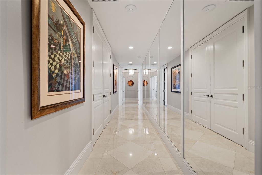 464 Golden Gate Point, Unit 703 Sarasota, FL 34236 - Photo 64 of 88 a view of a hallway with wooden floor and windows