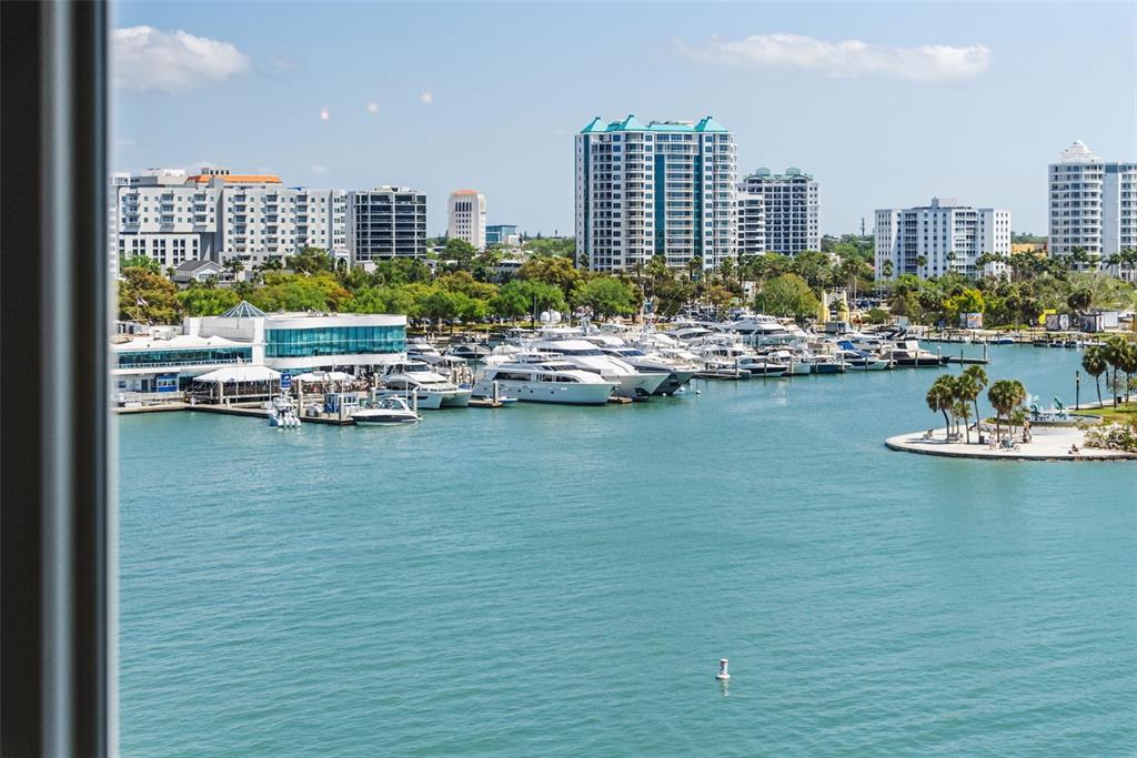 464 Golden Gate Point, Unit 703 Sarasota, FL 34236 - Photo 10 of 88 a view of a lake with tall building