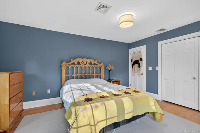 a spacious bathroom with a granite countertop sink a toilet and a bathtub