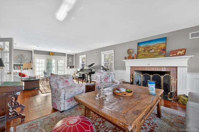 a living room with furniture a table and a fireplace