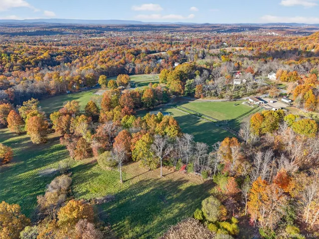 an aerial view of a house with a yard basket ball court and outdoor seating