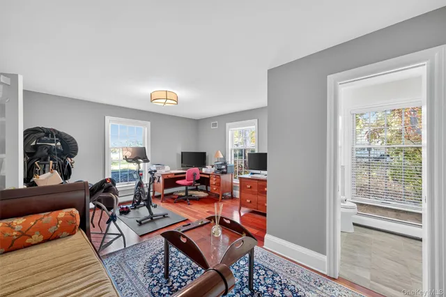 a living room with furniture a rug and a window