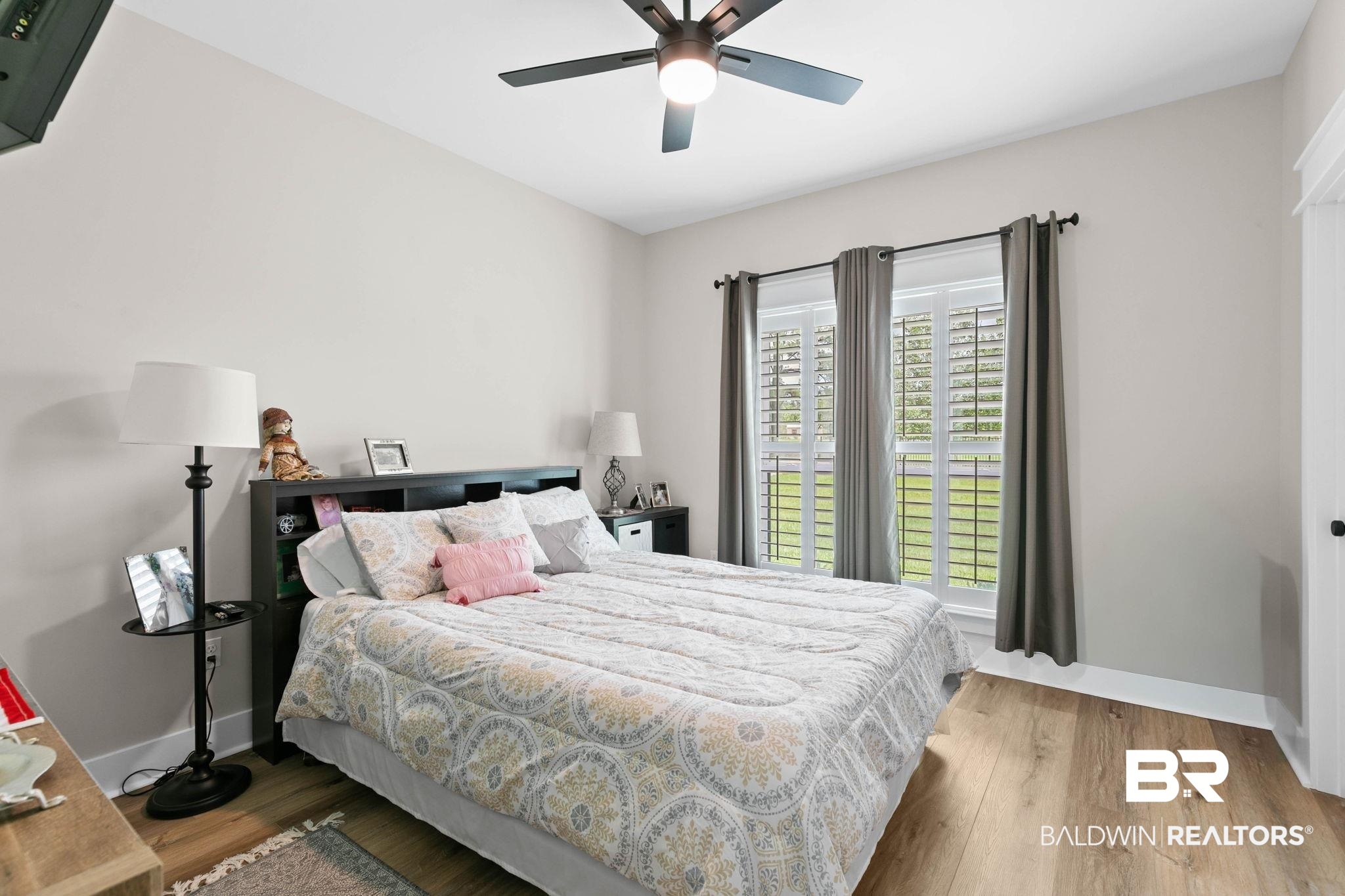 2029 George Lee Road Repton, AL 36475 - Photo 34 of 58 Bedroom featuring wood-finish flooring, a ceiling fan with integrated lighting, and a double window with plantation shutters
