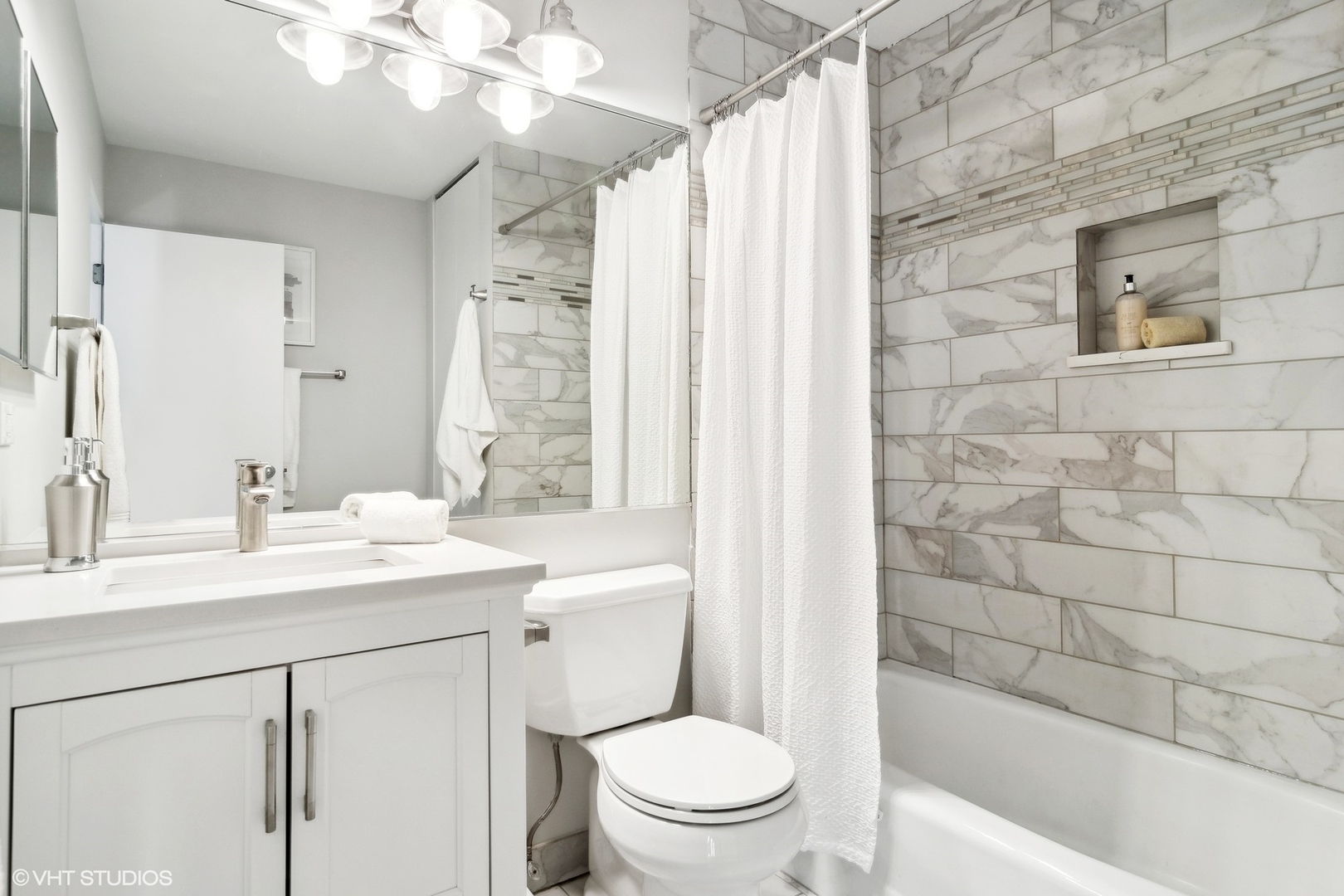 844 South Morgan Street Chicago, IL 60607 - Photo 8 of 10 a bathroom with a sink a toilet and shower