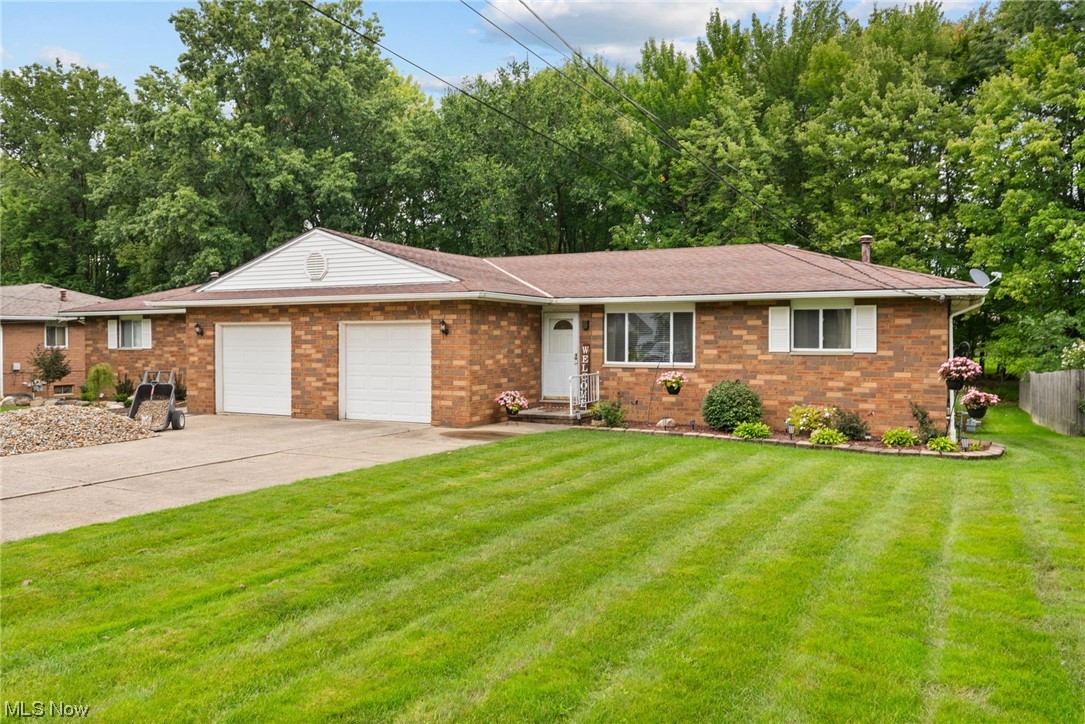 9935 Fair Road Strongsville, OH 44149 - Photo 1 of 34 Ranch-style house featuring garage and a front yard