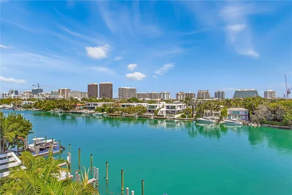a view of a lake with boats and trees in the background