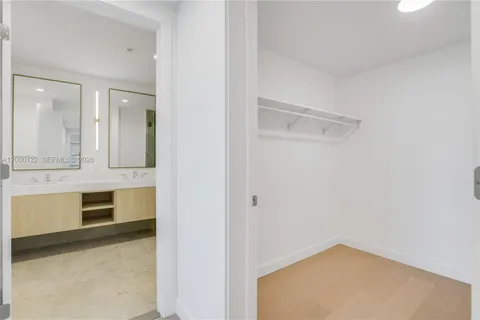 a white bath tub sitting next to a shower