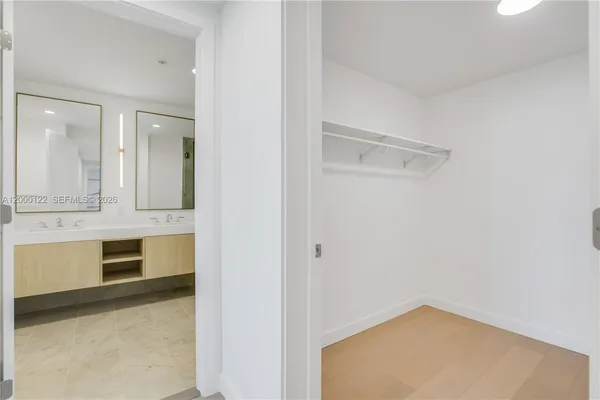 a white bath tub sitting next to a shower