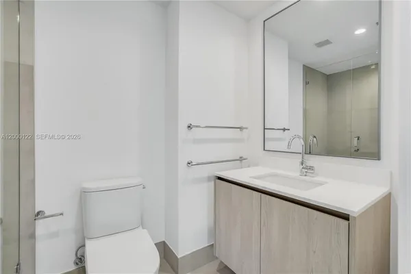 a bathroom with a shower sink and mirror