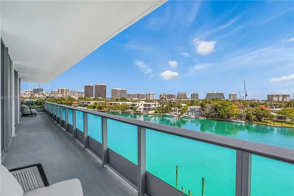 a view of a building with a large windows and a table and chair
