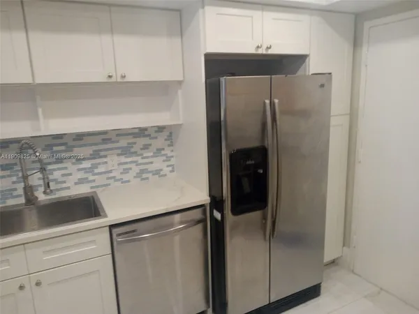 a kitchen with appliances and cabinets