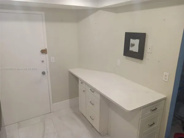 a utility room with cabinets washer and dryer