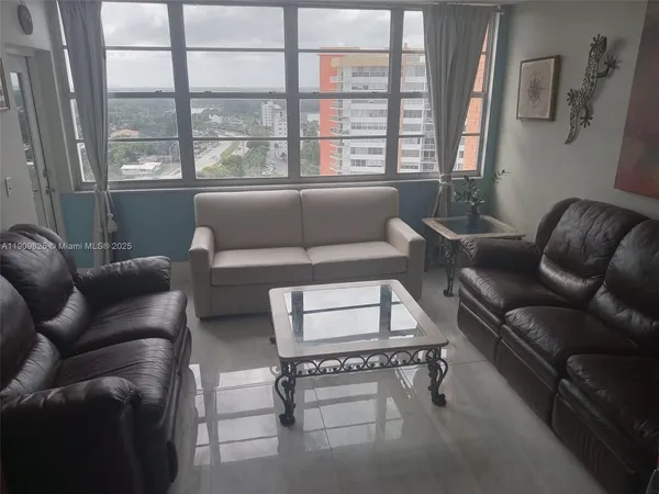 a living room with furniture and a window