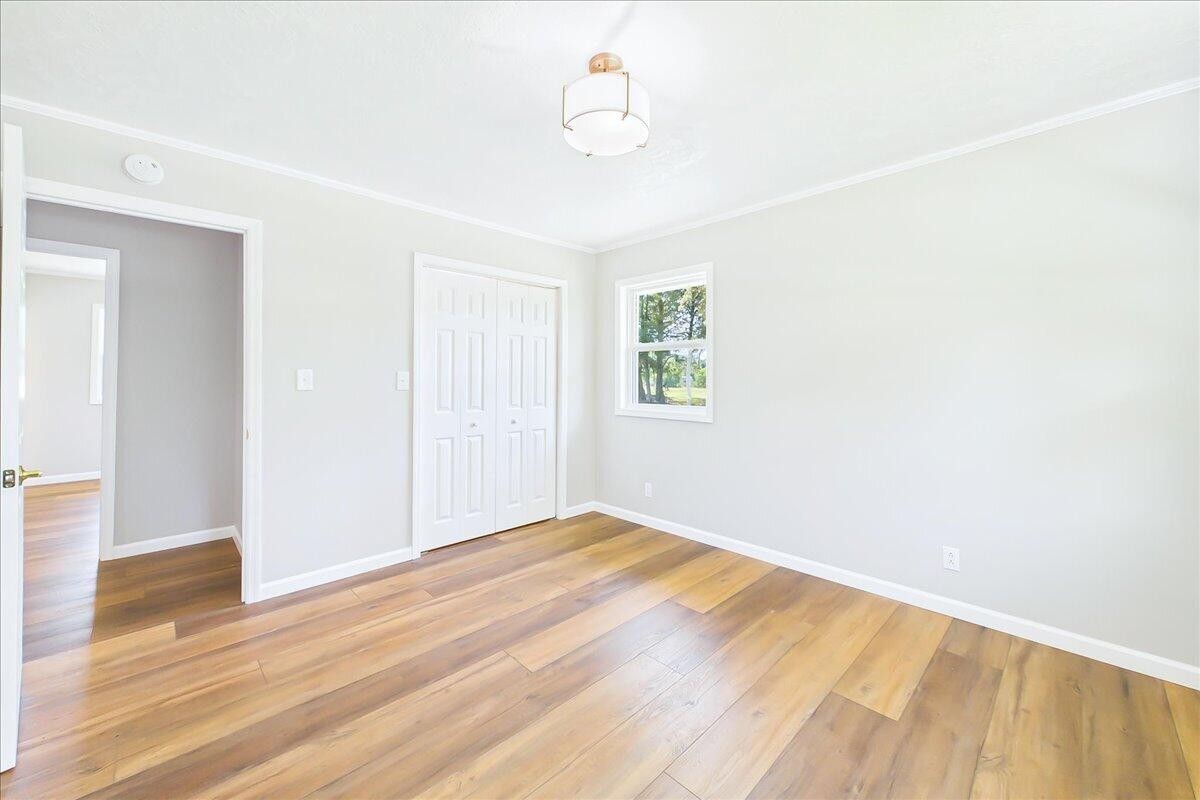 858 Main Street Decatur, TN 37322 - Photo 35 of 65 a view of an empty room with wooden floor and a window