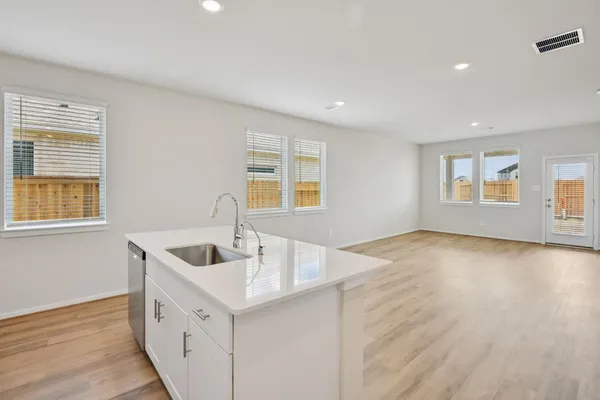 a kitchen with sink and windows