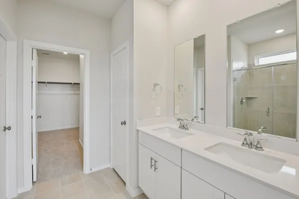 a bathroom with a double vanity sink mirror and double