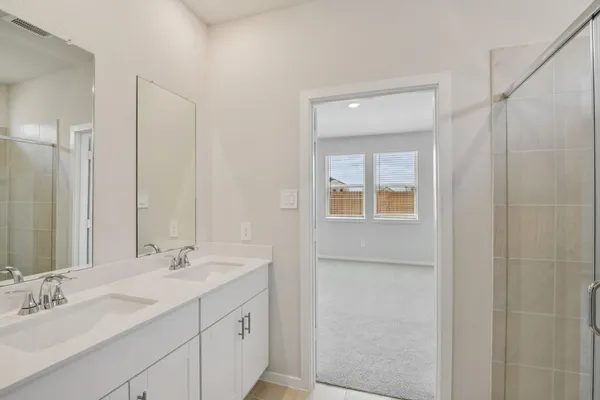 a bathroom with a double vanity sink mirror and