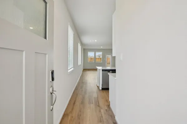 a view of hallway with wooden floor