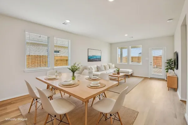 a view of a dining room with furniture and wooden floor