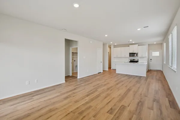 a view of a kitchen with a sink and wooden floor