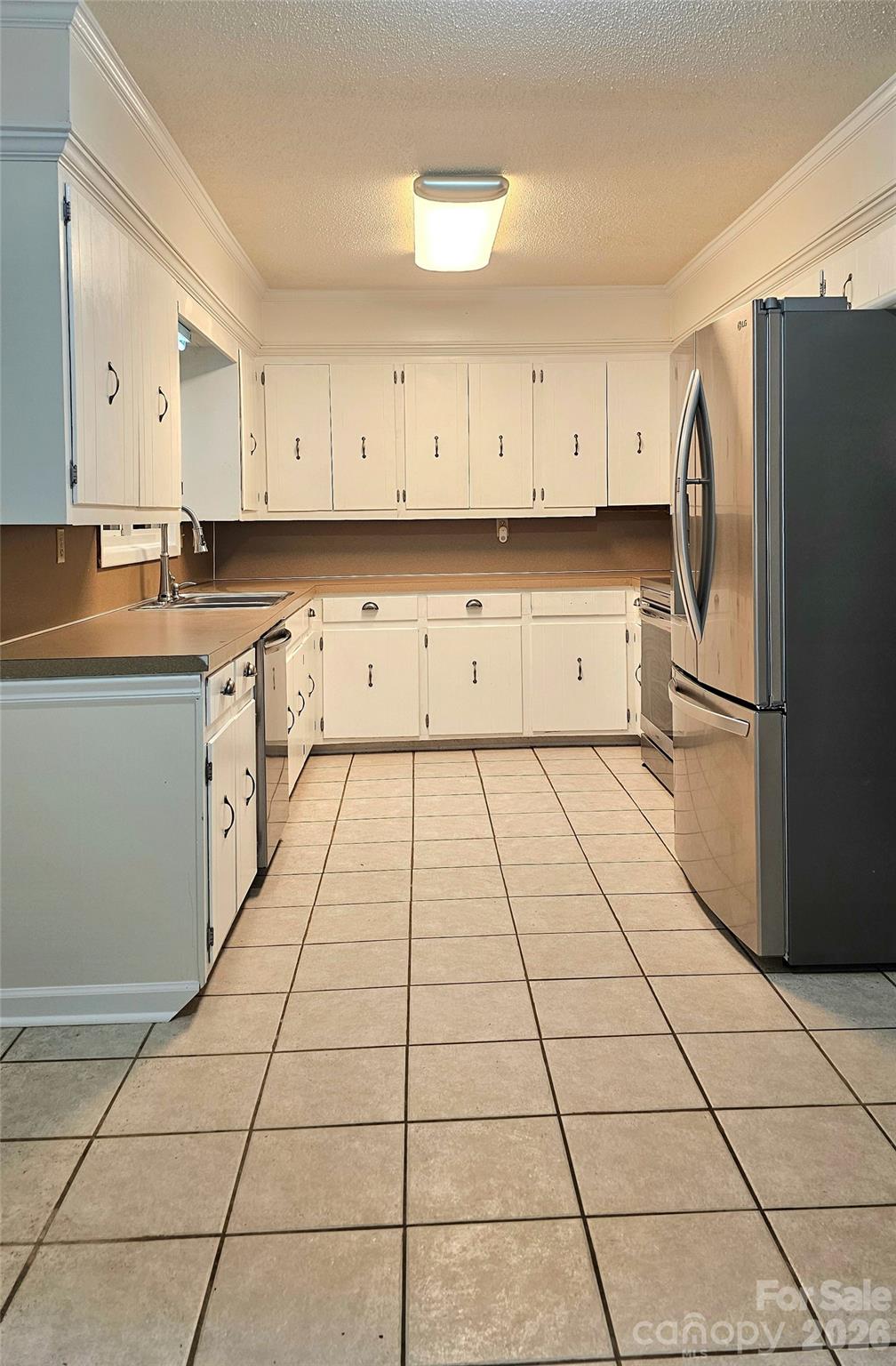 107 Oakgrove Street Locust, NC 28097 - Photo 11 of 32 a kitchen with a stove a sink and a refrigerator