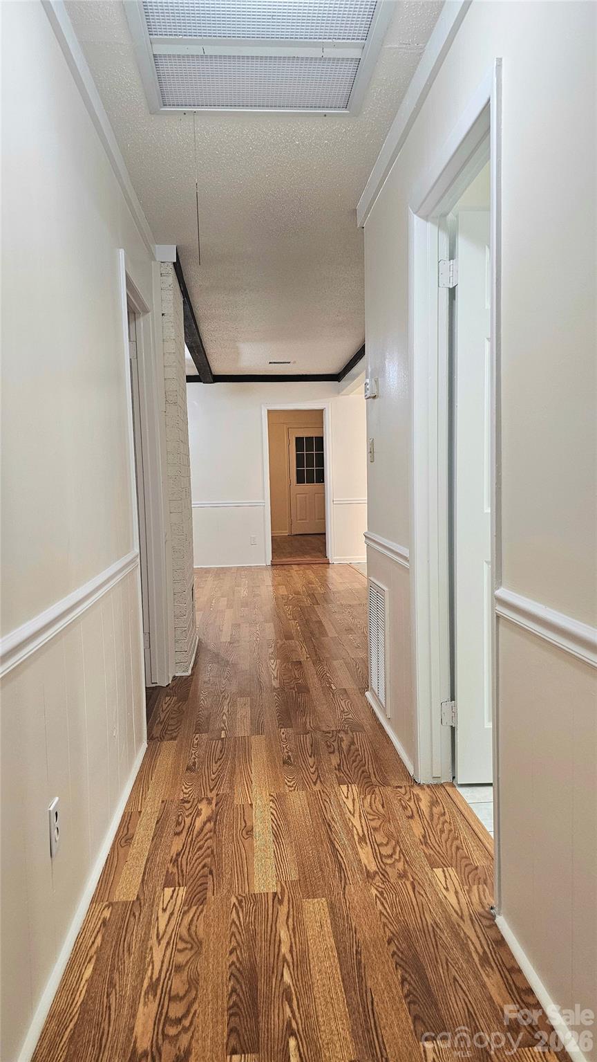107 Oakgrove Street Locust, NC 28097 - Photo 15 of 32 a view of a hallway with wooden floor and staircase