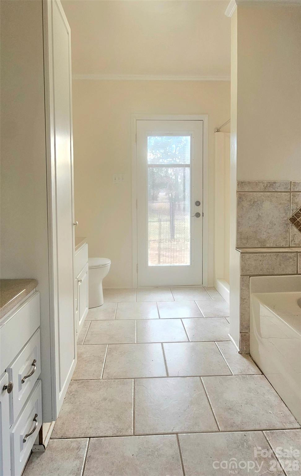107 Oakgrove Street Locust, NC 28097 - Photo 17 of 32 a bathroom with a sink toilet and tub