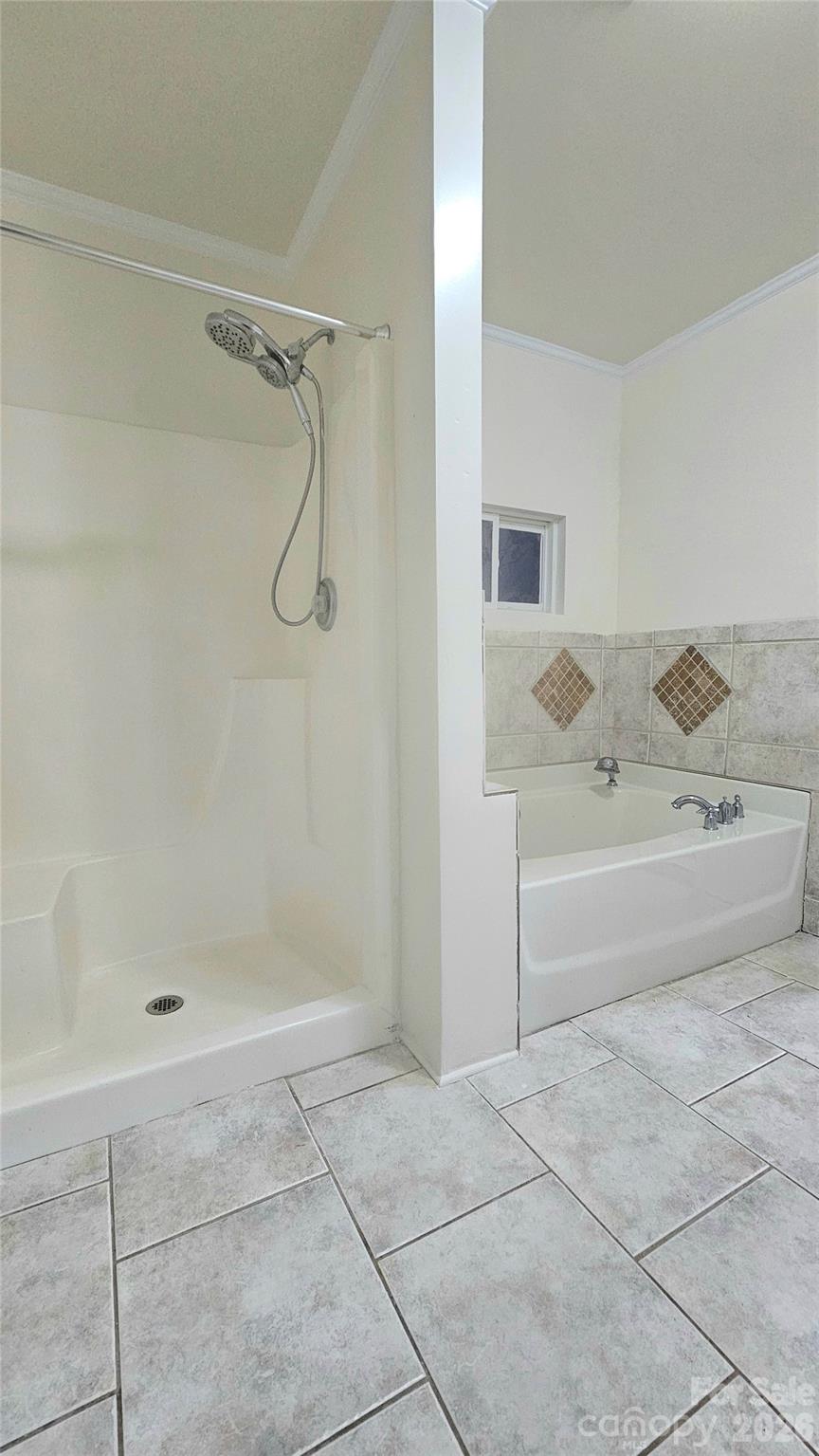 107 Oakgrove Street Locust, NC 28097 - Photo 18 of 32 a bathroom with a bathtub and shower
