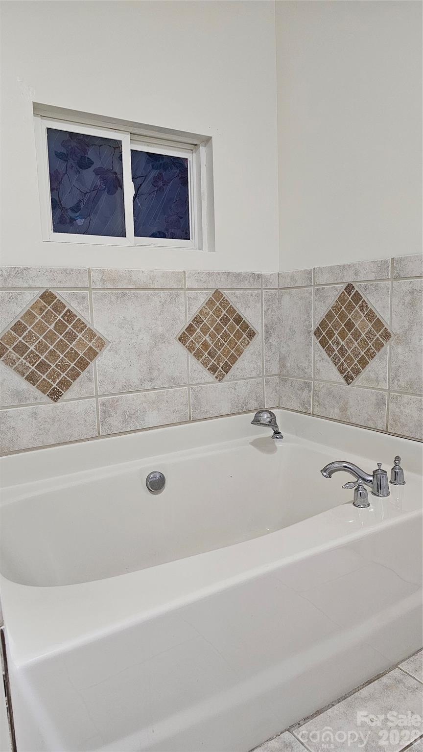 107 Oakgrove Street Locust, NC 28097 - Photo 20 of 32 a bathroom with a bathtub