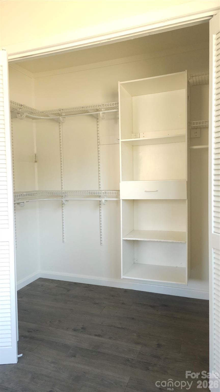 107 Oakgrove Street Locust, NC 28097 - Photo 22 of 32 a view of an empty room with wooden floor and a window