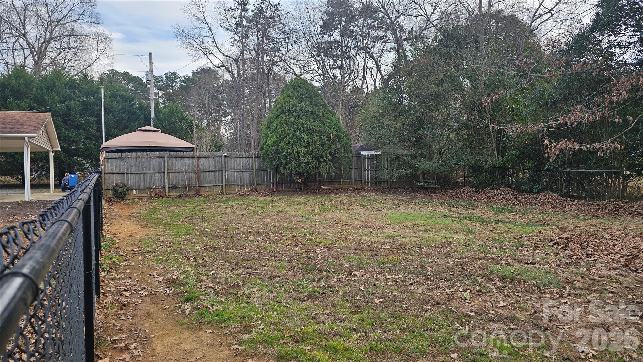 107 Oakgrove Street Locust, NC 28097 - Photo 4 of 32 a backyard of a house with lots of green space