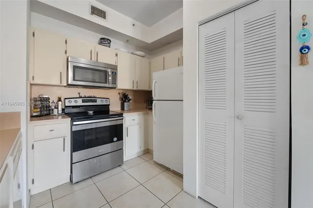 a white refrigerator freezer sitting in a kitchen