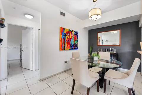 a view of a dining room with furniture and a chandelier