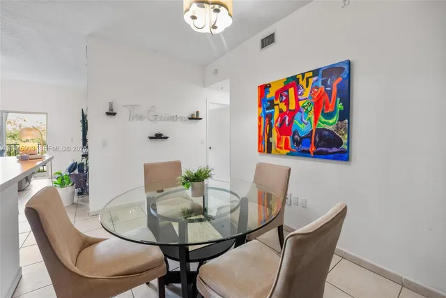 a large bed sitting in a bedroom next to a window