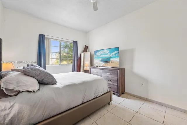 a bedroom with a bed and dresser