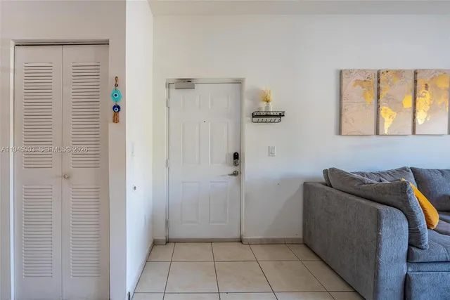 a living room with furniture a flat screen tv and a window