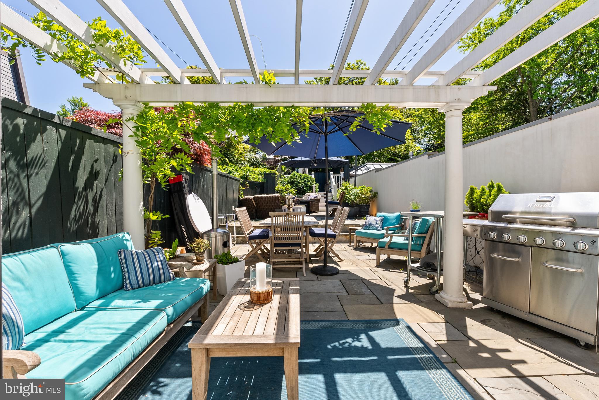 2708 O Street Northwest Washington, DC 20007 - Photo 4 of 12 a view of a patio with table and chairs potted plants with wooden floor