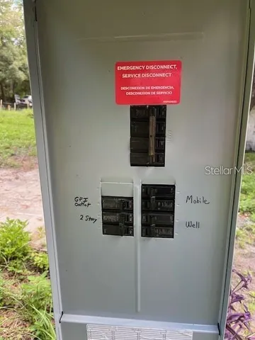 a view of a yard with plants and trees