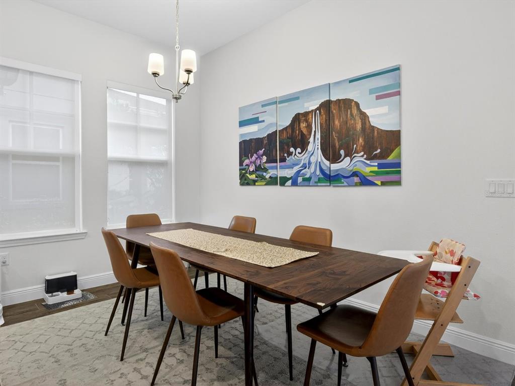 9952 Rodbell Street Orlando, FL 32827 - Photo 11 of 44 a view of a dining room with furniture and chandelier