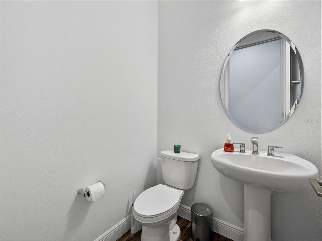 9952 Rodbell Street Orlando, FL 32827 - Photo 12 of 44 a bathroom with a toilet a sink and mirror