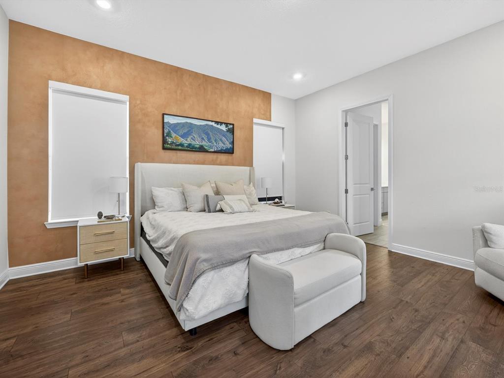 9952 Rodbell Street Orlando, FL 32827 - Photo 14 of 44 a spacious bedroom with a bed and a couch