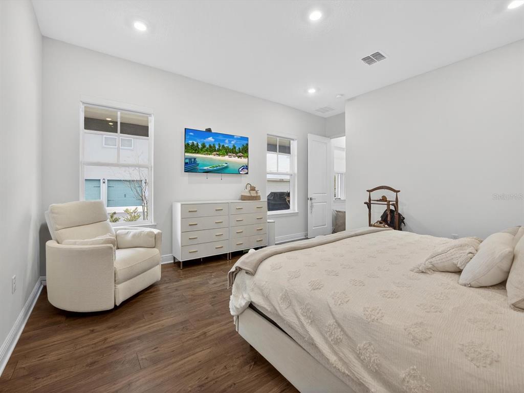 9952 Rodbell Street Orlando, FL 32827 - Photo 16 of 44 a spacious bedroom with a bed and a couch