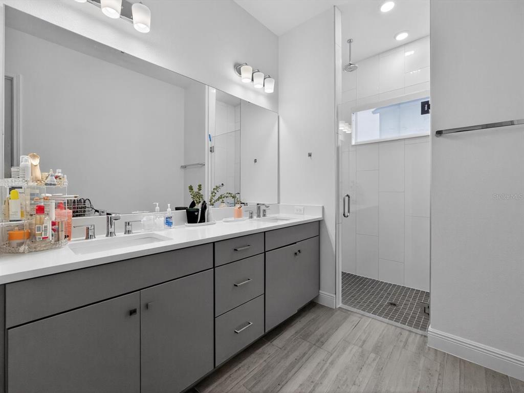 9952 Rodbell Street Orlando, FL 32827 - Photo 17 of 44 a bathroom with a double vanity sink and mirror