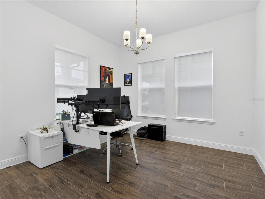 9952 Rodbell Street Orlando, FL 32827 - Photo 18 of 44 a workspace with wooden floor