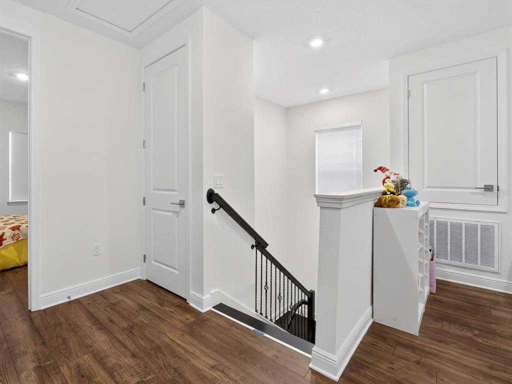 9952 Rodbell Street Orlando, FL 32827 - Photo 23 of 44 a view of hallway with wooden floor